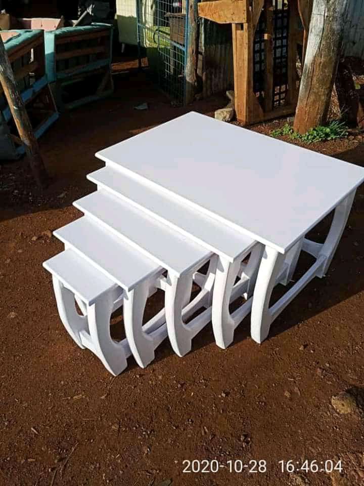 White nest of stools, 5 pcs with board as top white in color.