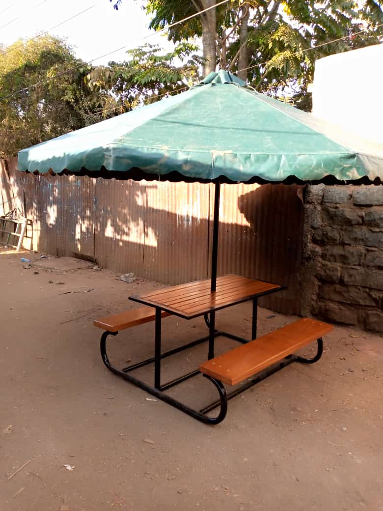 Umbrella tent with two benches.
