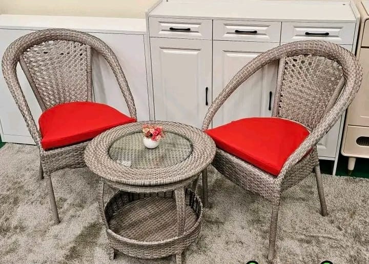 2 seater rattan seats with a round table.